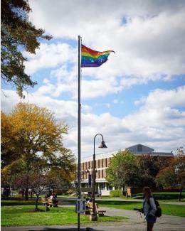 Photo of a rainbow flag flying over IC academic quad