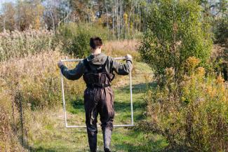A student performs environmental studies in a forest. 
