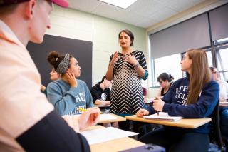 Belisa González teaches a group of students in a classroom.