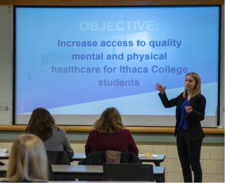 A student is presenting in front of an audience
